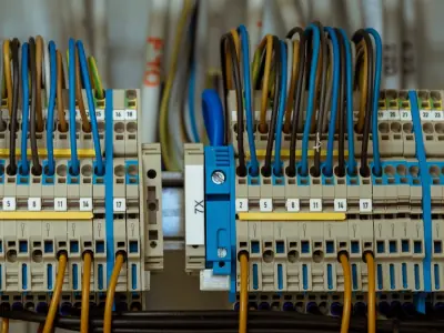 Neatly wired electrical terminal blocks and circuit connections in an upgraded switchboard.